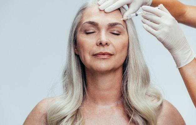 a woman having botox injection in her forehead | Botox | 7 Different Saggy Skin Solutions