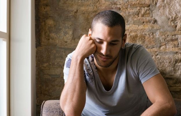 an exhausted man is sitting - ca | Hormone Replacement Therapy For Men | What is Testosterone Deficiency?